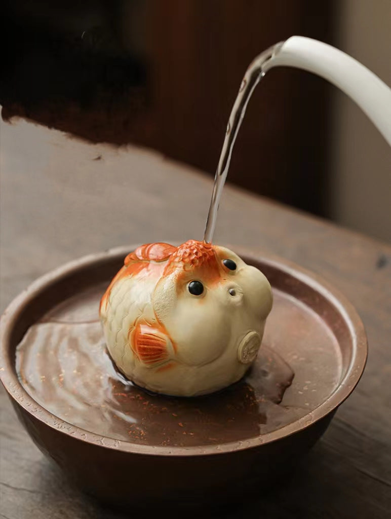 This is a Yixing purple clay bubble fish teapet