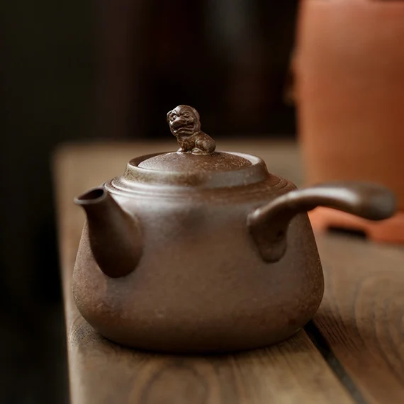 This is a pottery side handle kettle