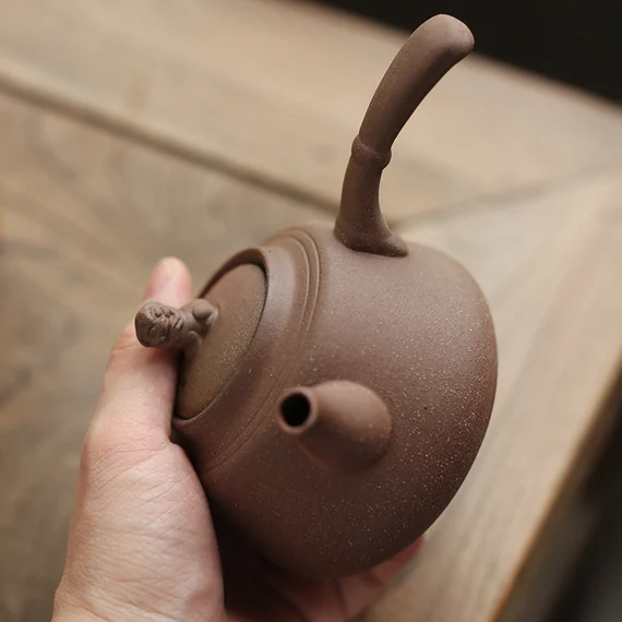 This is a pottery side handle kettle