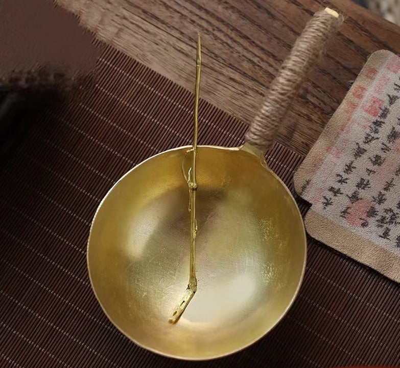 This is a copper tea scoop