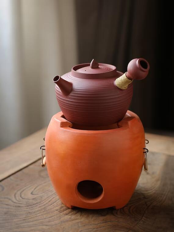 This is a pottery side handle kettle