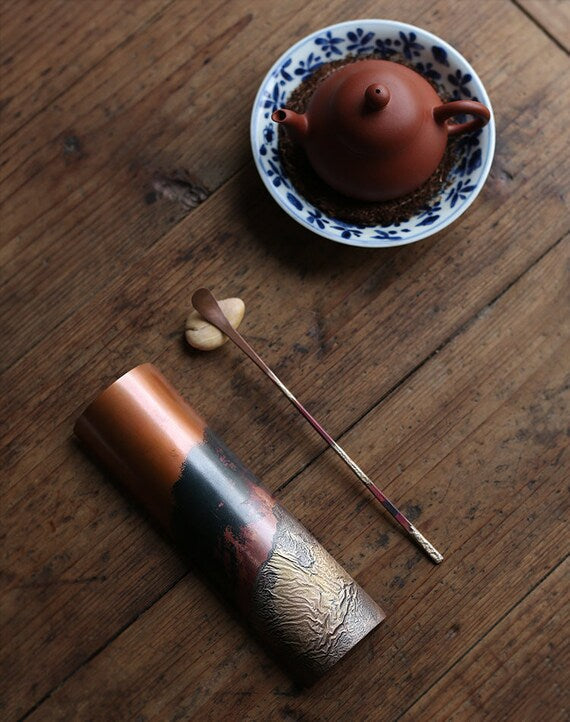 This is a copper tea scoop