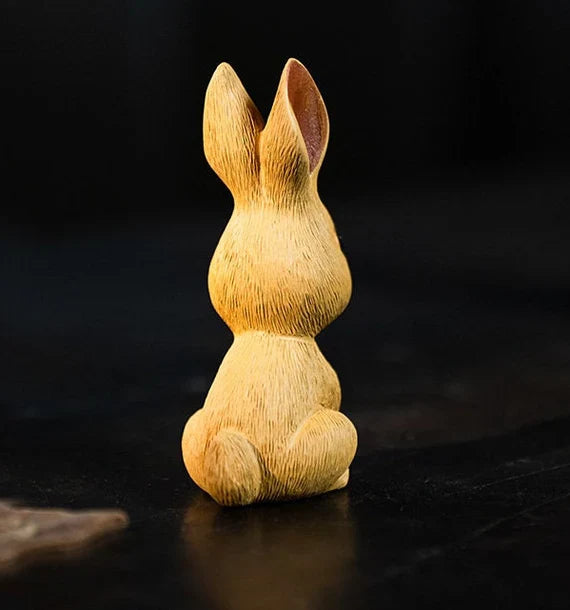 This is a Yixing purple clay rabbit teapet