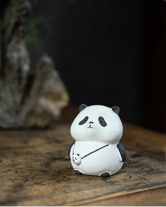 This is a Yixing purple clay panda teapet