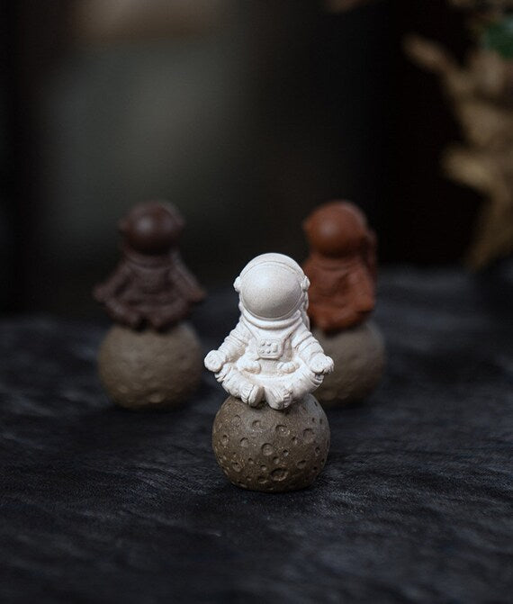 This is a Yixing purple clay meditation astronaut teapet