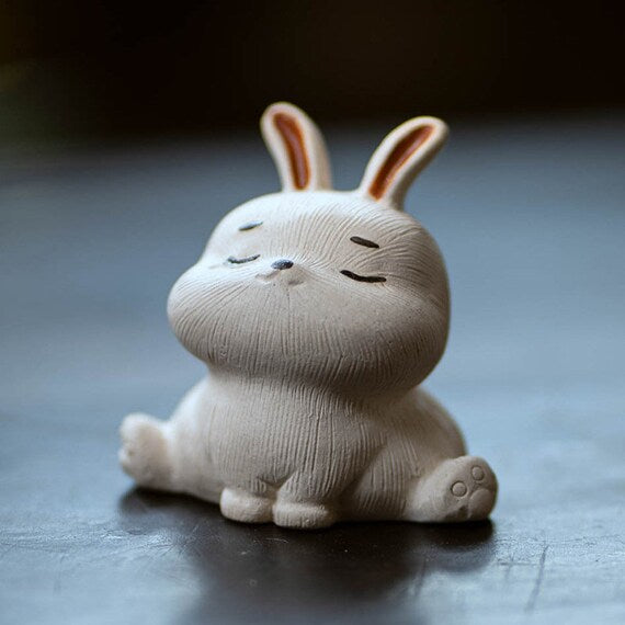 This is a Yixing purple clay rabbit teapet