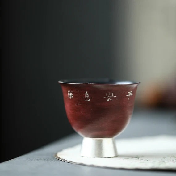 This is a pottery teacup.This is a gilted silver teacup