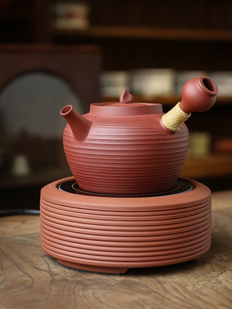 This is a pottery side handle kettle