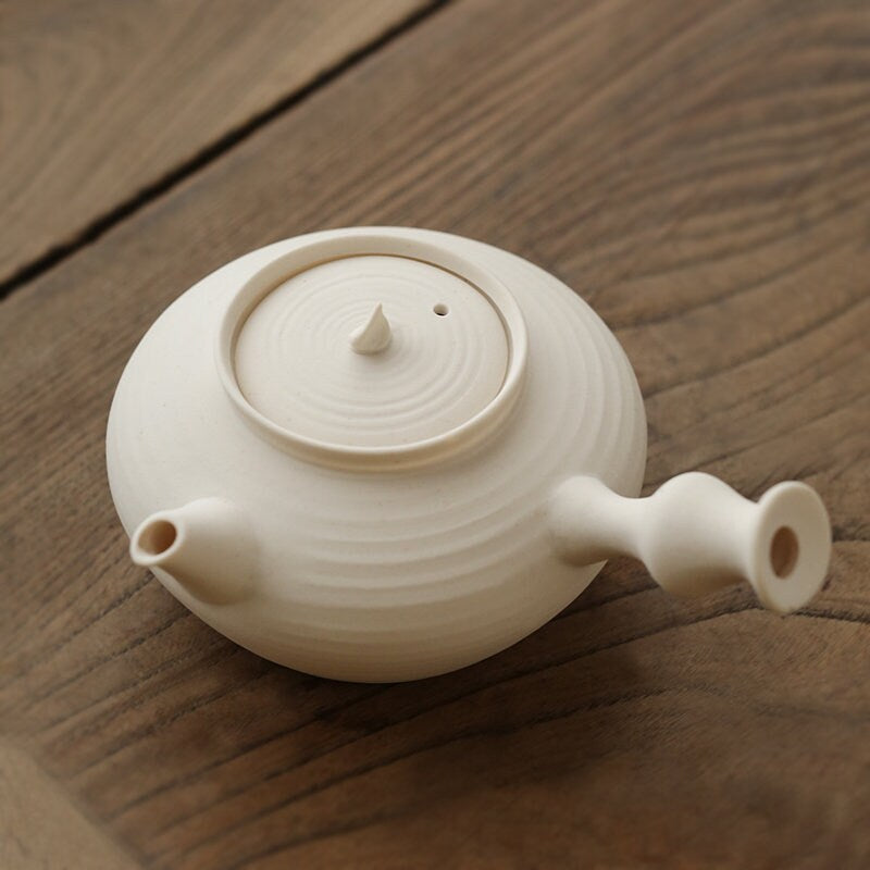 This is a pottery side handle kettle