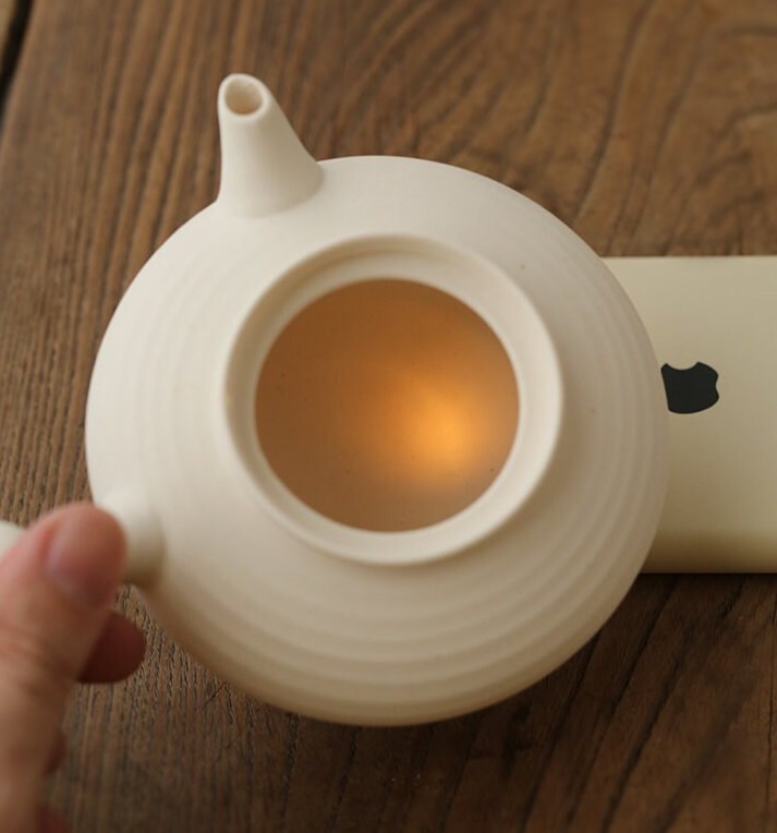 This is a pottery side handle kettle