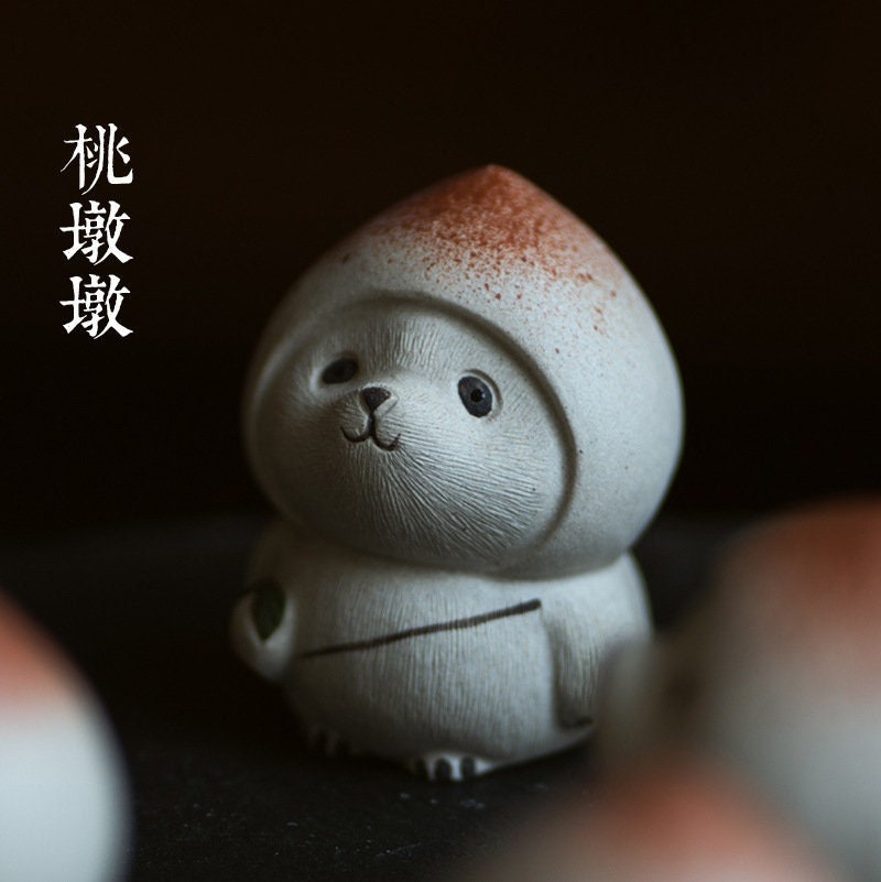 This is a Yixing purple clay peach panda teapet