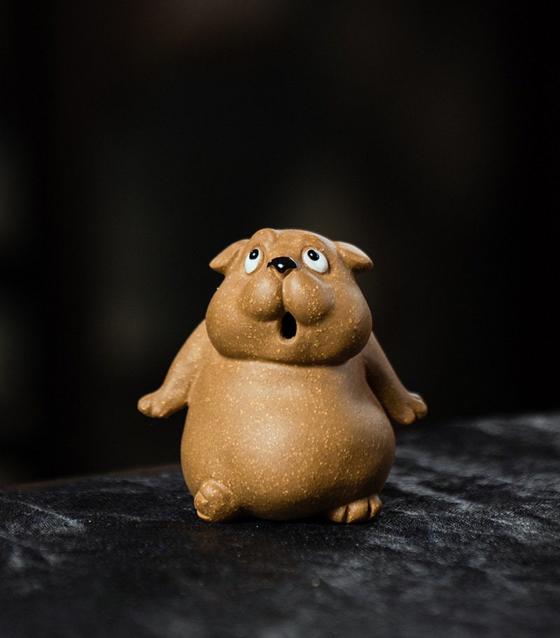 This is a Yixing purple clay dog teapet