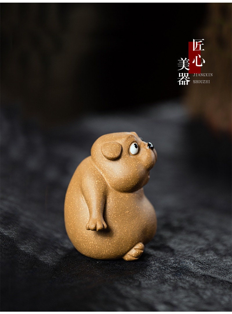 This is a Yixing purple clay dog teapet