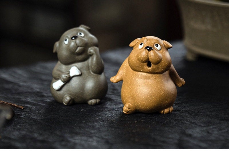 This is a Yixing purple clay dog teapet