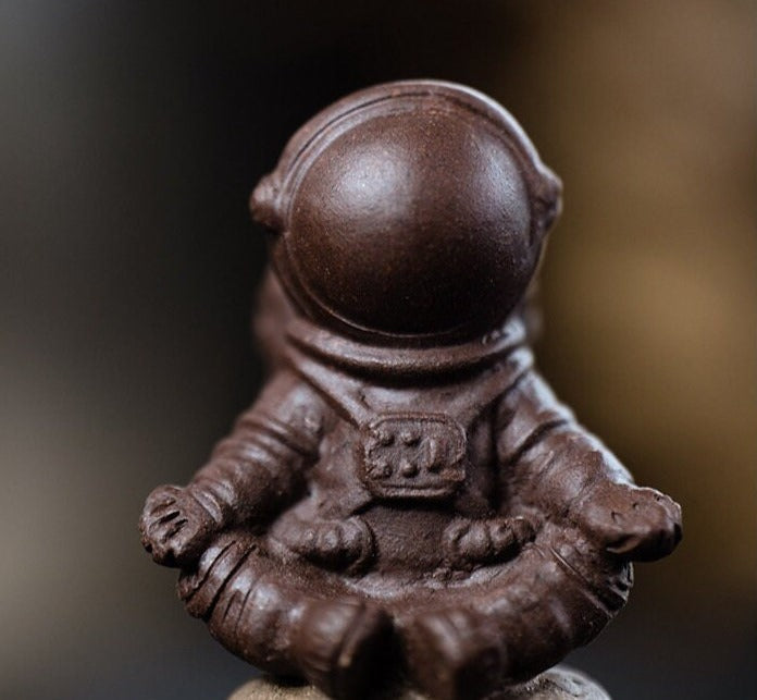 This is a Yixing purple clay meditation astronaut teapet