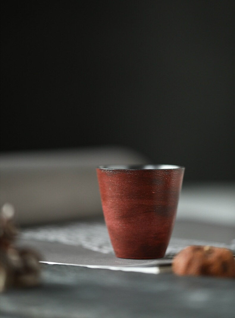 This is a pottery teacup.This is a gilted silver teacup